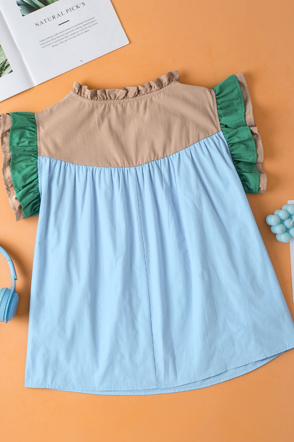 Color block notched ruffled cap sleeve blouse.