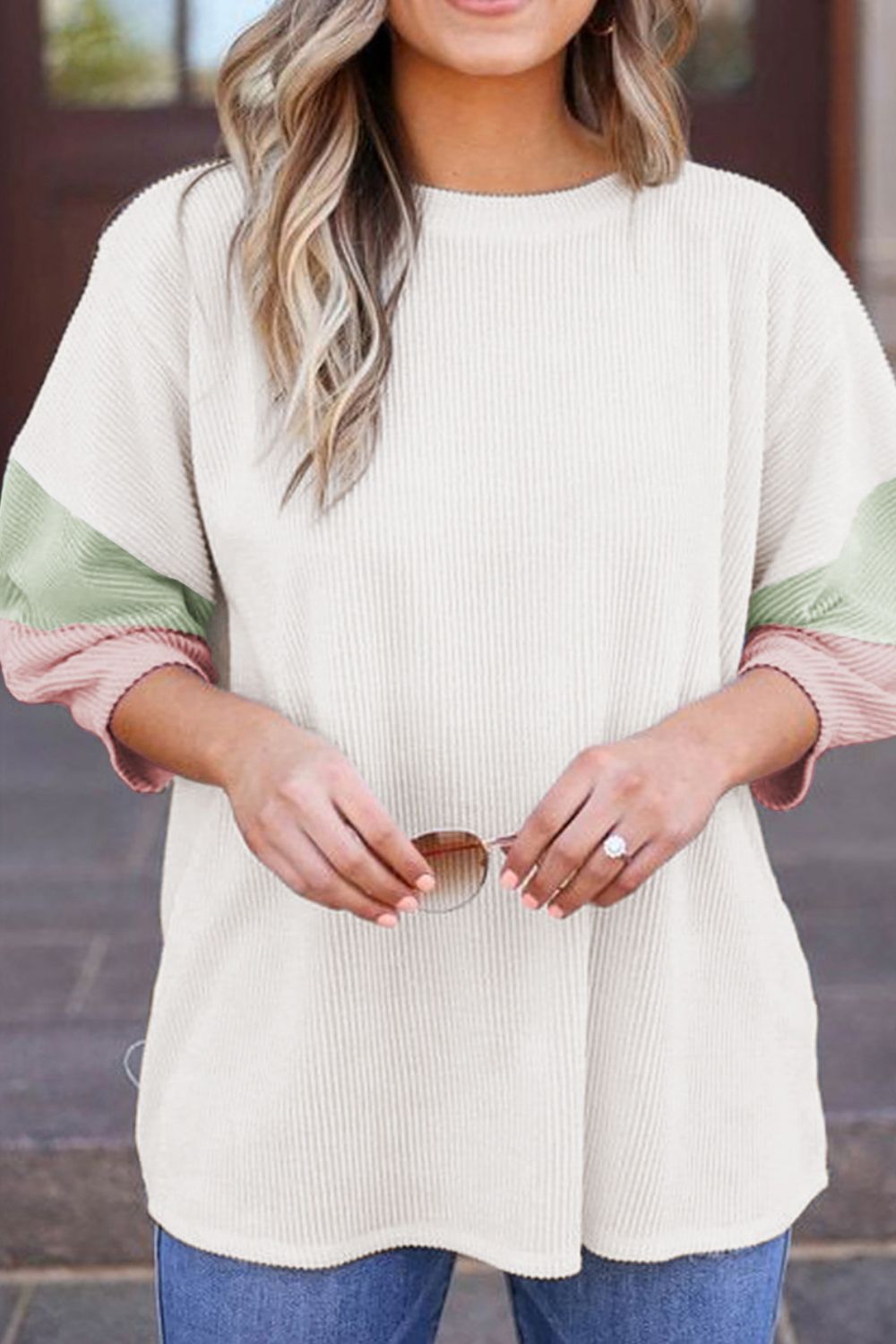 Color block ribbed knit three-quarter sleeve top.