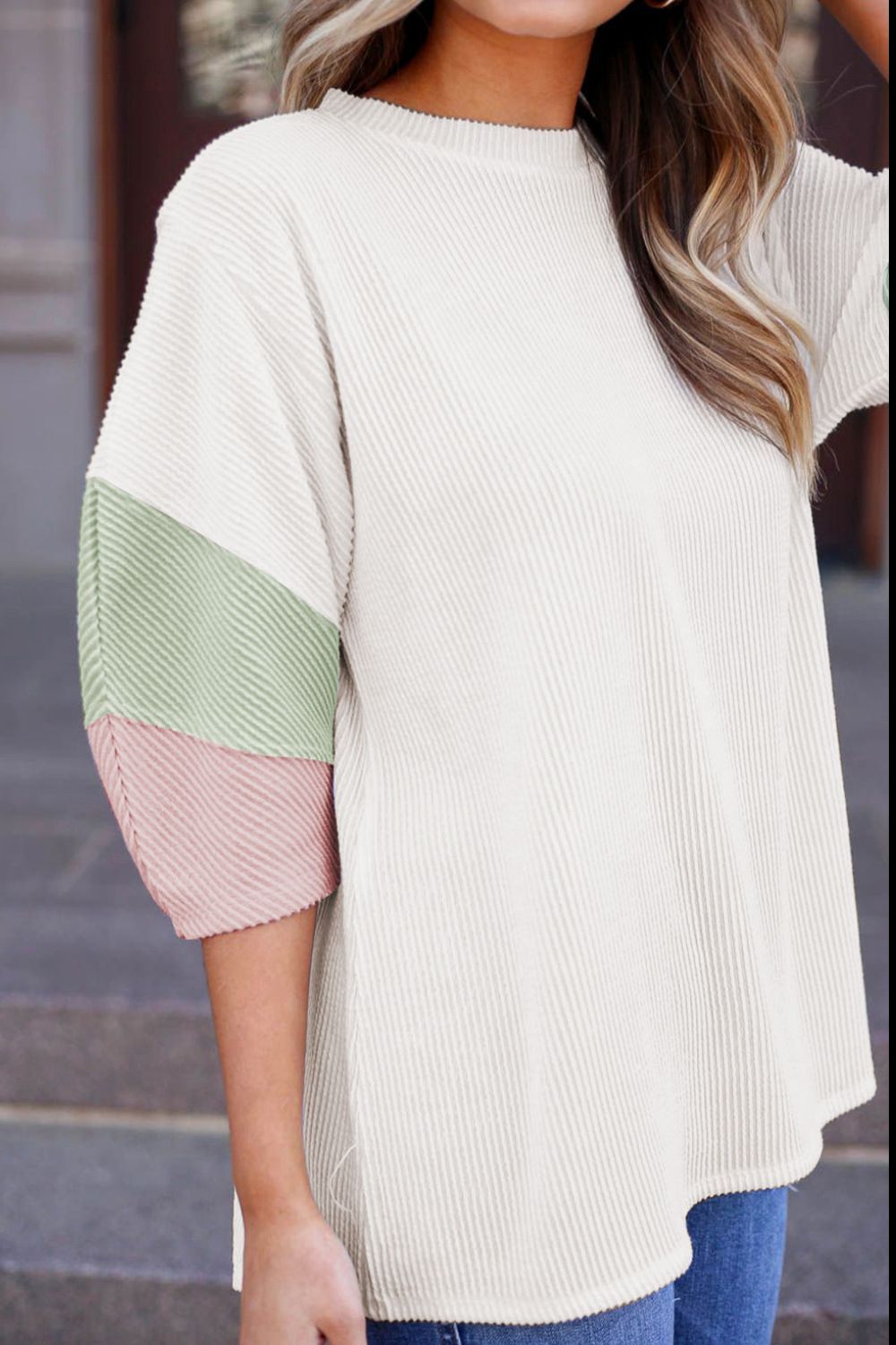 Color block ribbed knit three-quarter sleeve top.