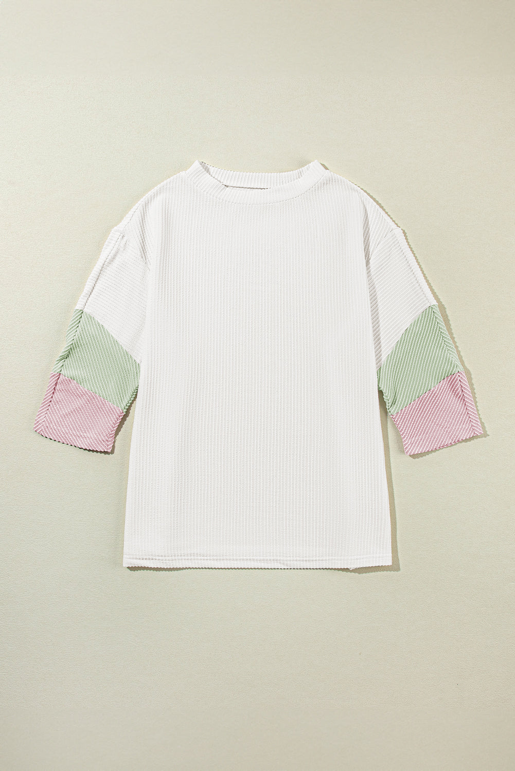 Color block ribbed knit three-quarter sleeve top.