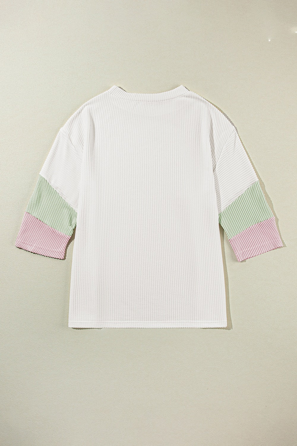 Color block ribbed knit three-quarter sleeve top.