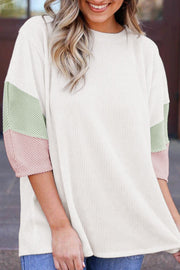 Color block ribbed knit three-quarter sleeve top.