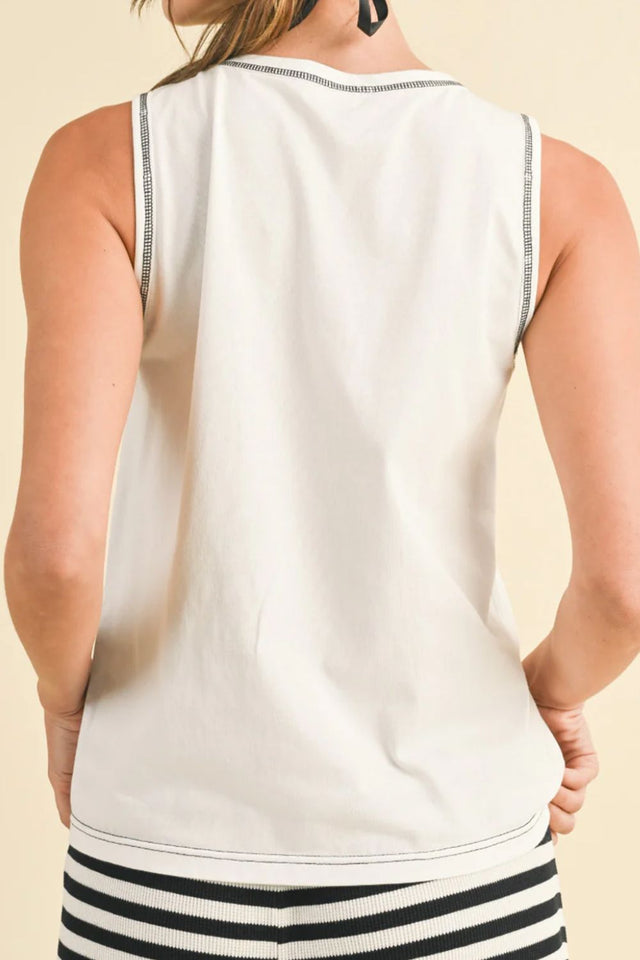 Round neck sleeveless top with contrast bow detail.
