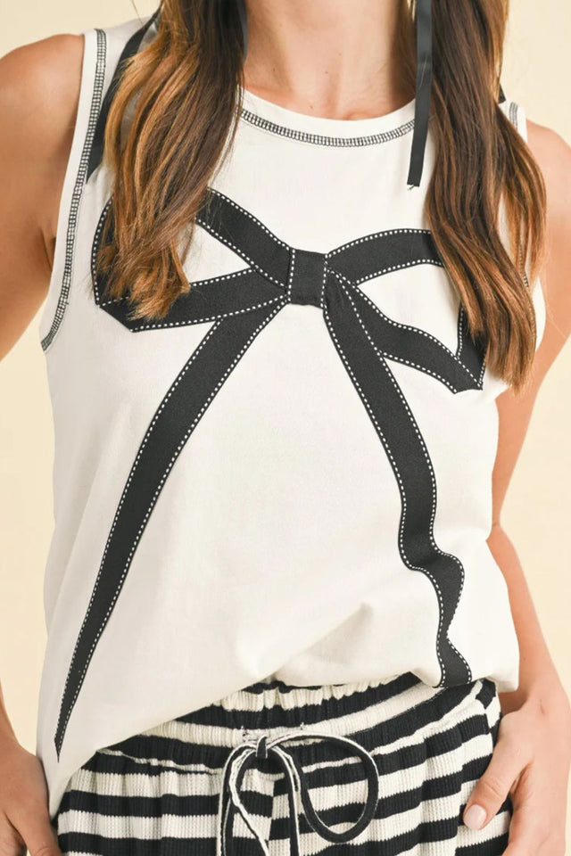 Round neck sleeveless top with contrast bow detail.