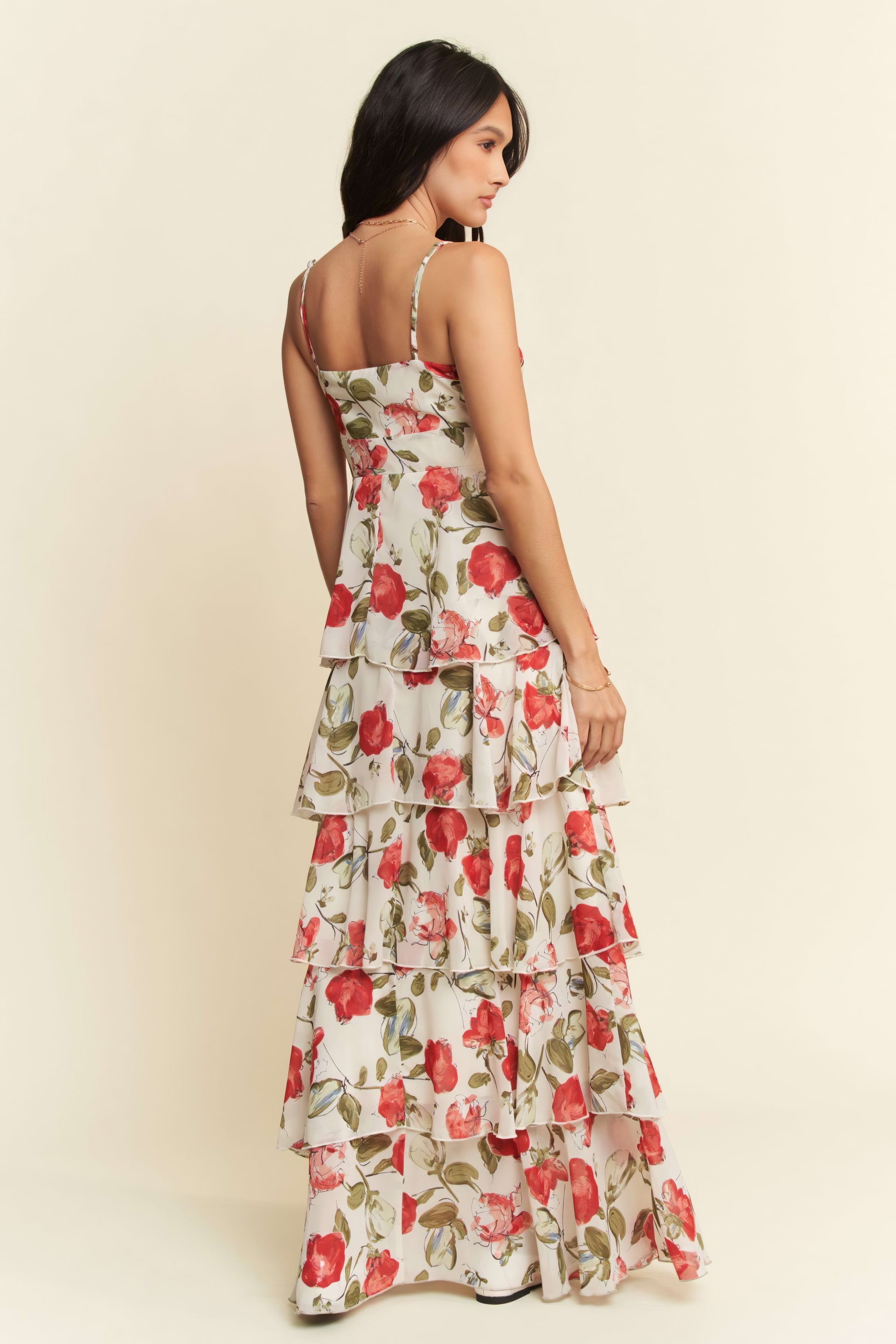 Woman wearing a floral dress against a plain background
