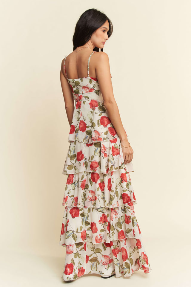 Woman wearing a floral dress against a plain background