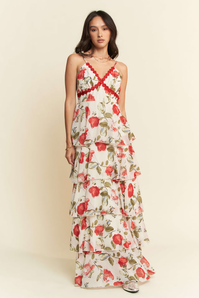 Woman wearing a floral dress with red flowers on a beige background