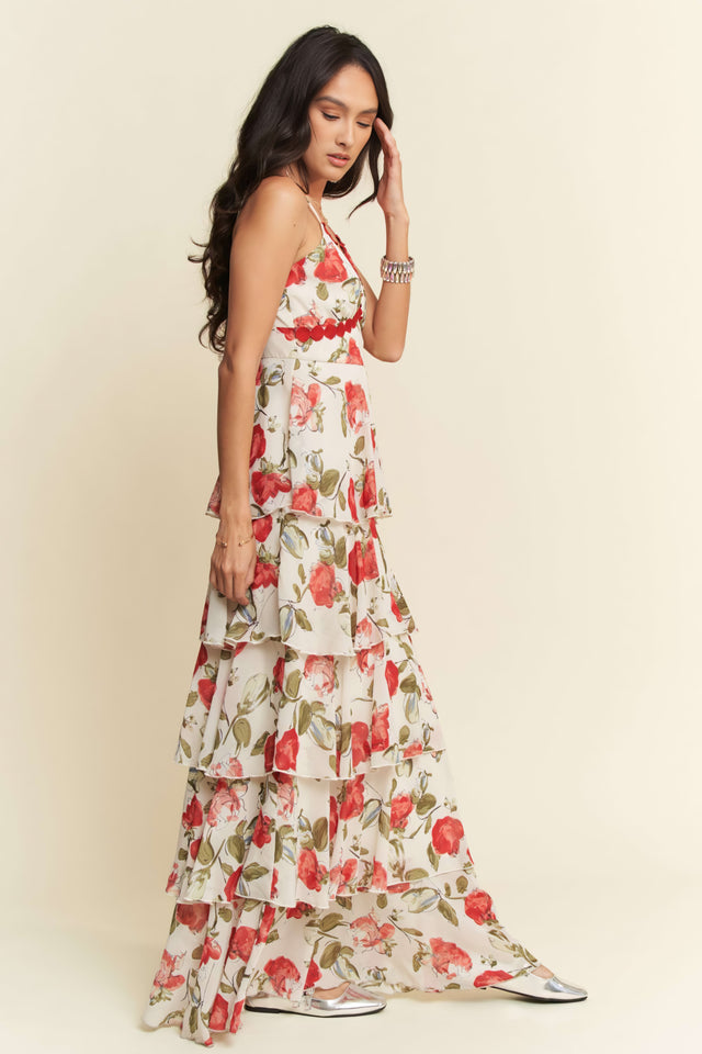 Woman wearing a floral dress against a plain background