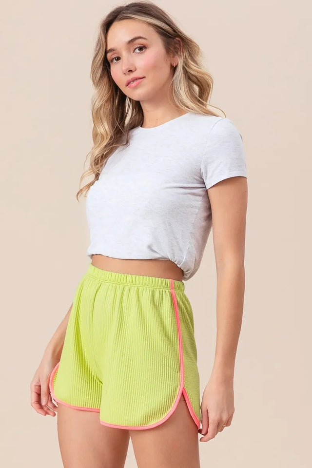 Cord rib shorts with band side slit, drawstring, and pockets.