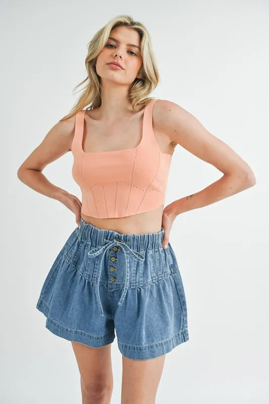 Corset design detail crop knit top with ribbed texture, moderately stretchy.