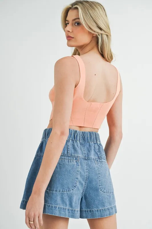 Corset design detail crop knit top with ribbed texture, moderately stretchy.