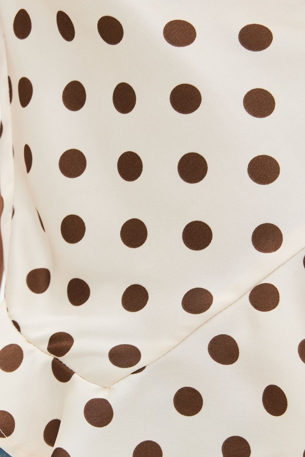 Crisscross ruffled hem polka dot cami with tied, ruched, and backless design.