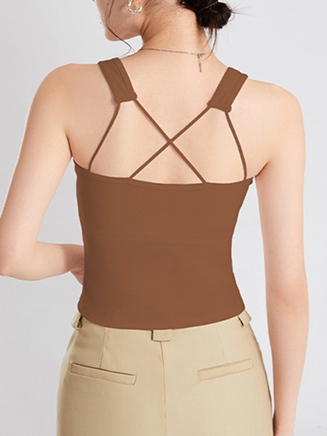 Crisscross scoop neck wide strap cropped tank top with chest pads.