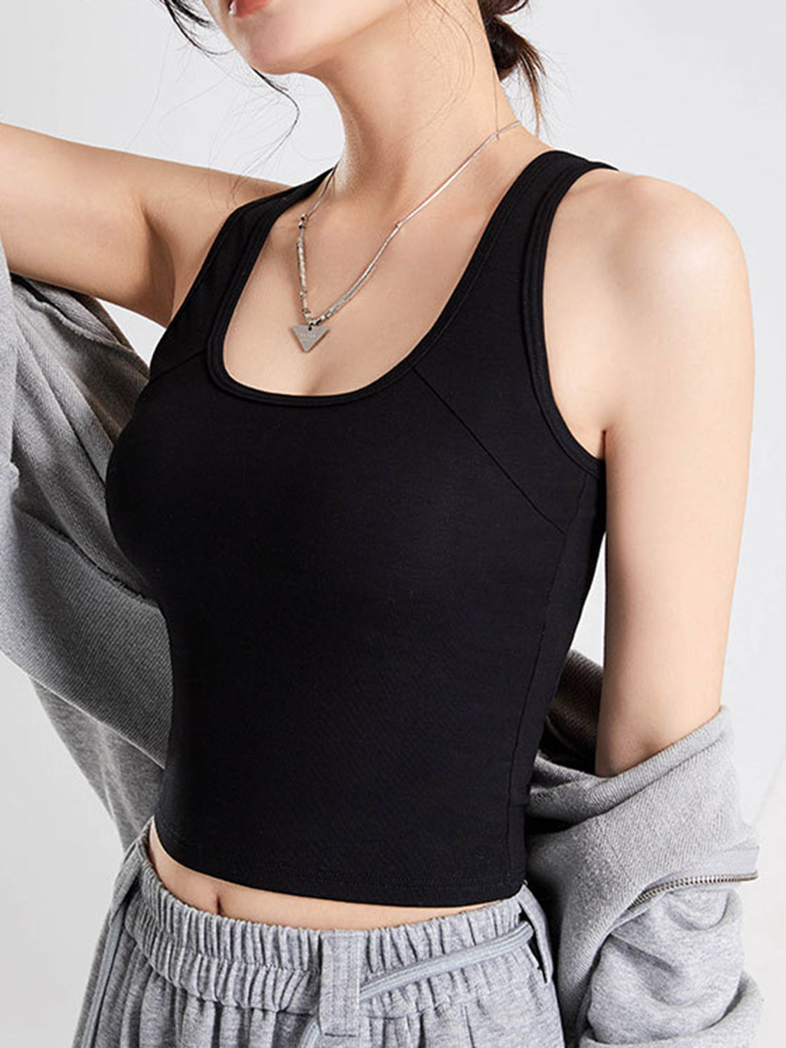 Crisscross scoop neck wide strap cropped tank top with chest pads.