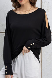 Cutout round neck long sleeve top with decorative buttons.