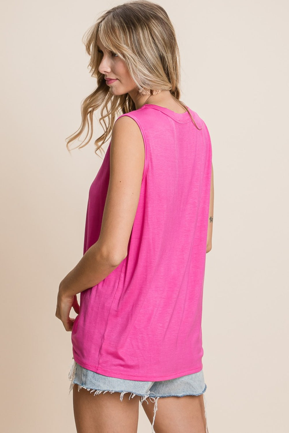 Cutout round neck sleeveless top, opaque.