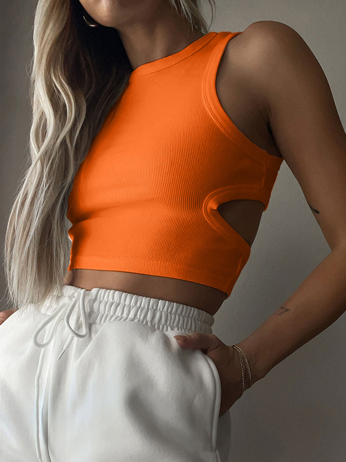 Round neck tank top with cutout details.