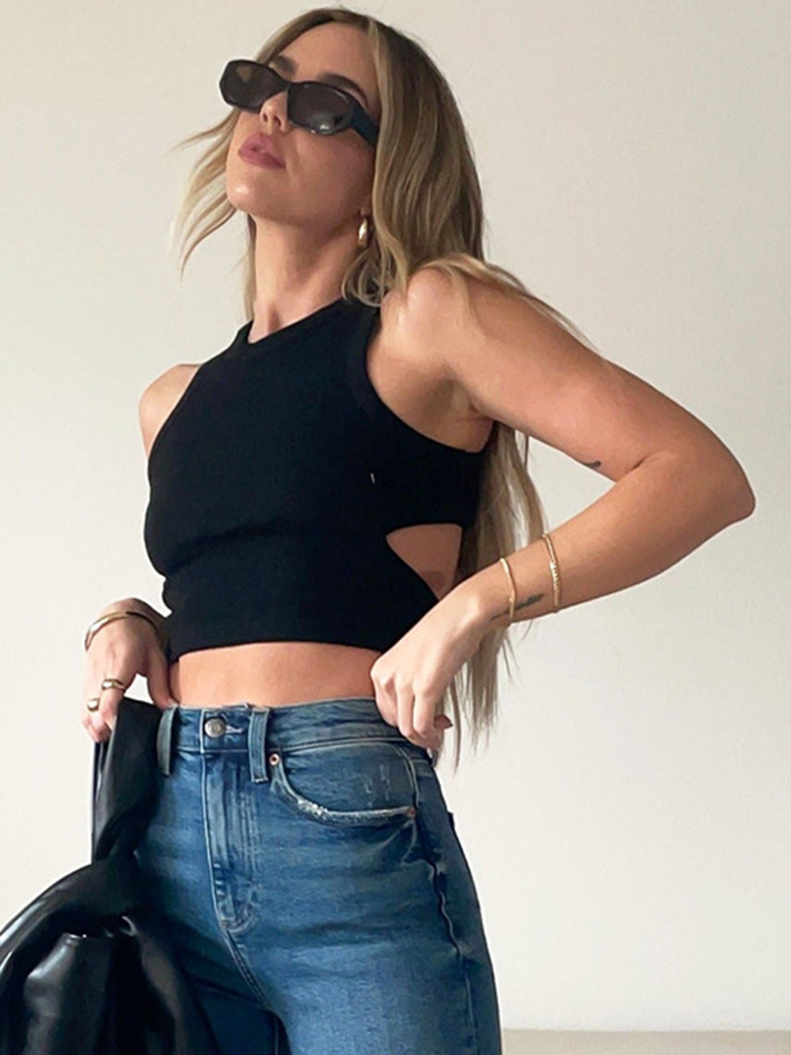 Round neck tank top with cutout details.