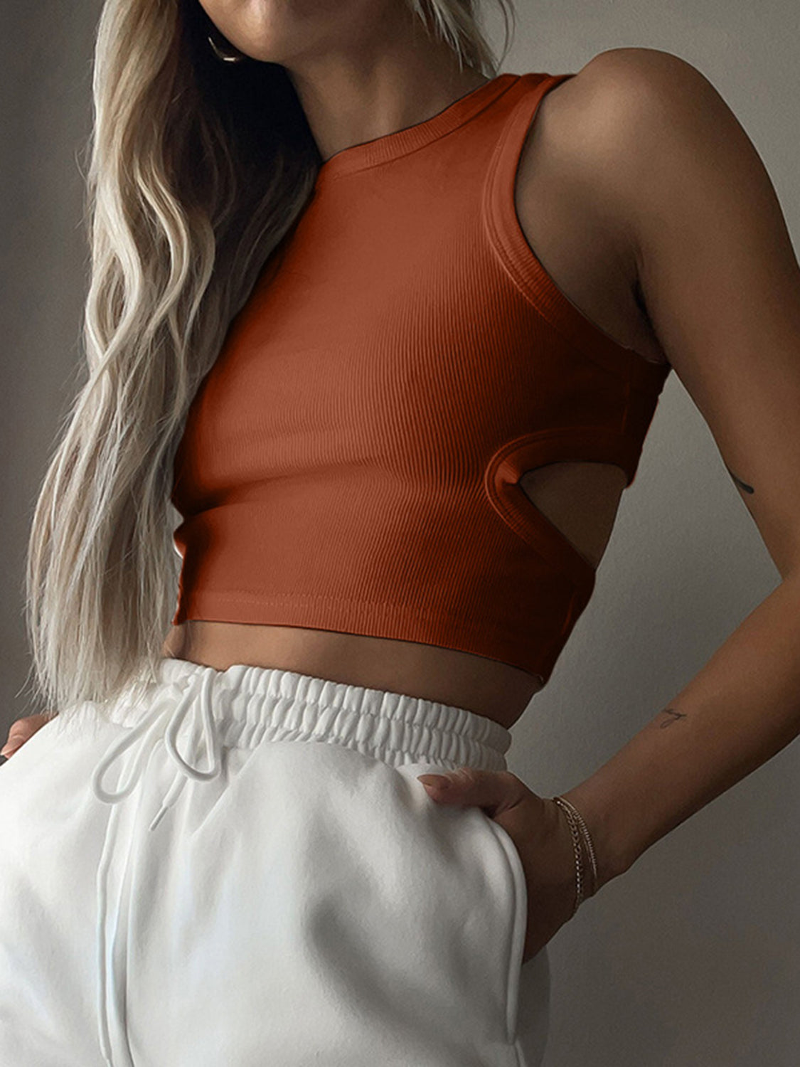Round neck tank top with cutout details.