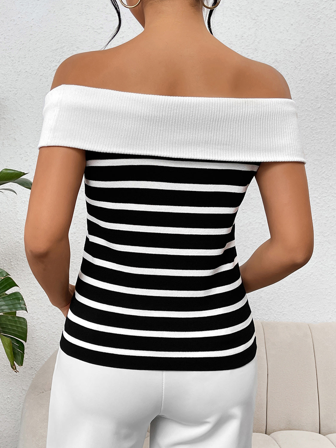 Decorative button striped off-shoulder knit top.