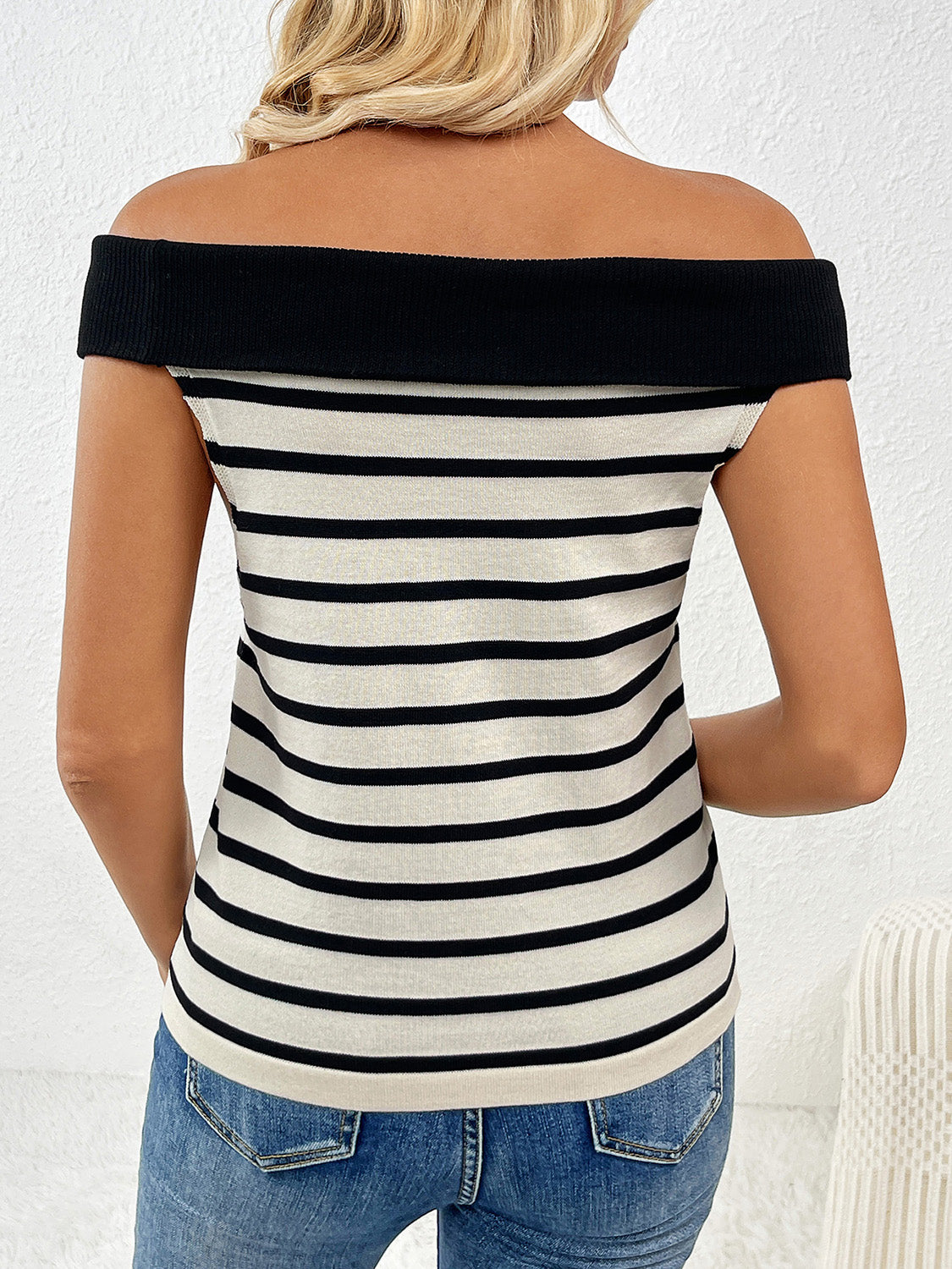 Decorative button striped off-shoulder knit top.