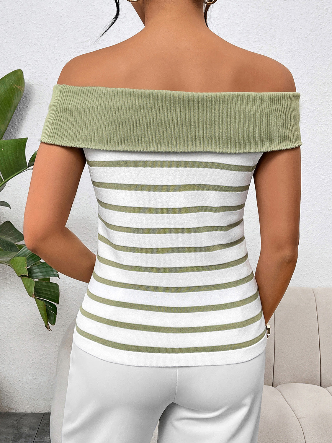 Decorative button striped off-shoulder knit top.
