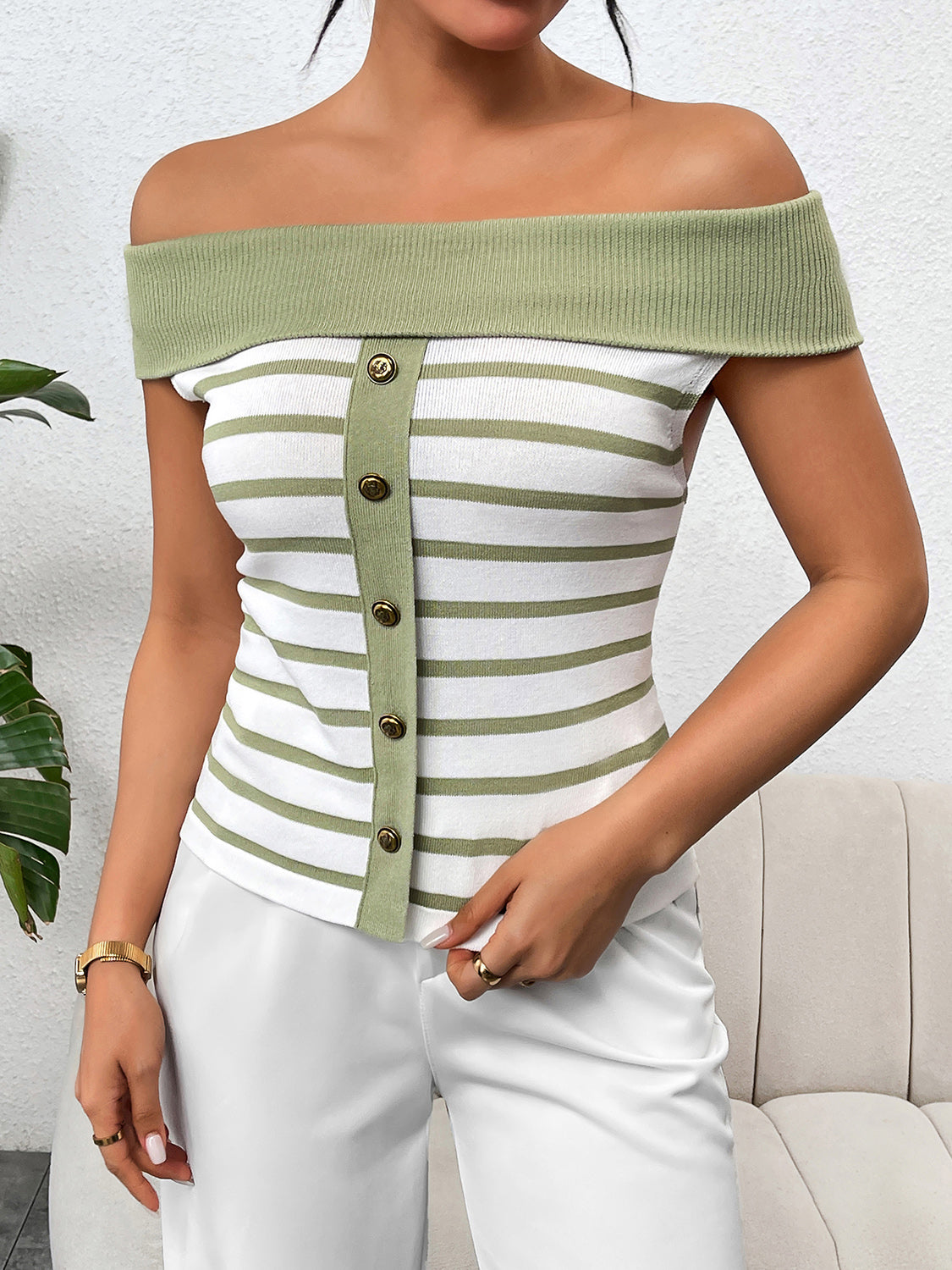 Decorative button striped off-shoulder knit top.
