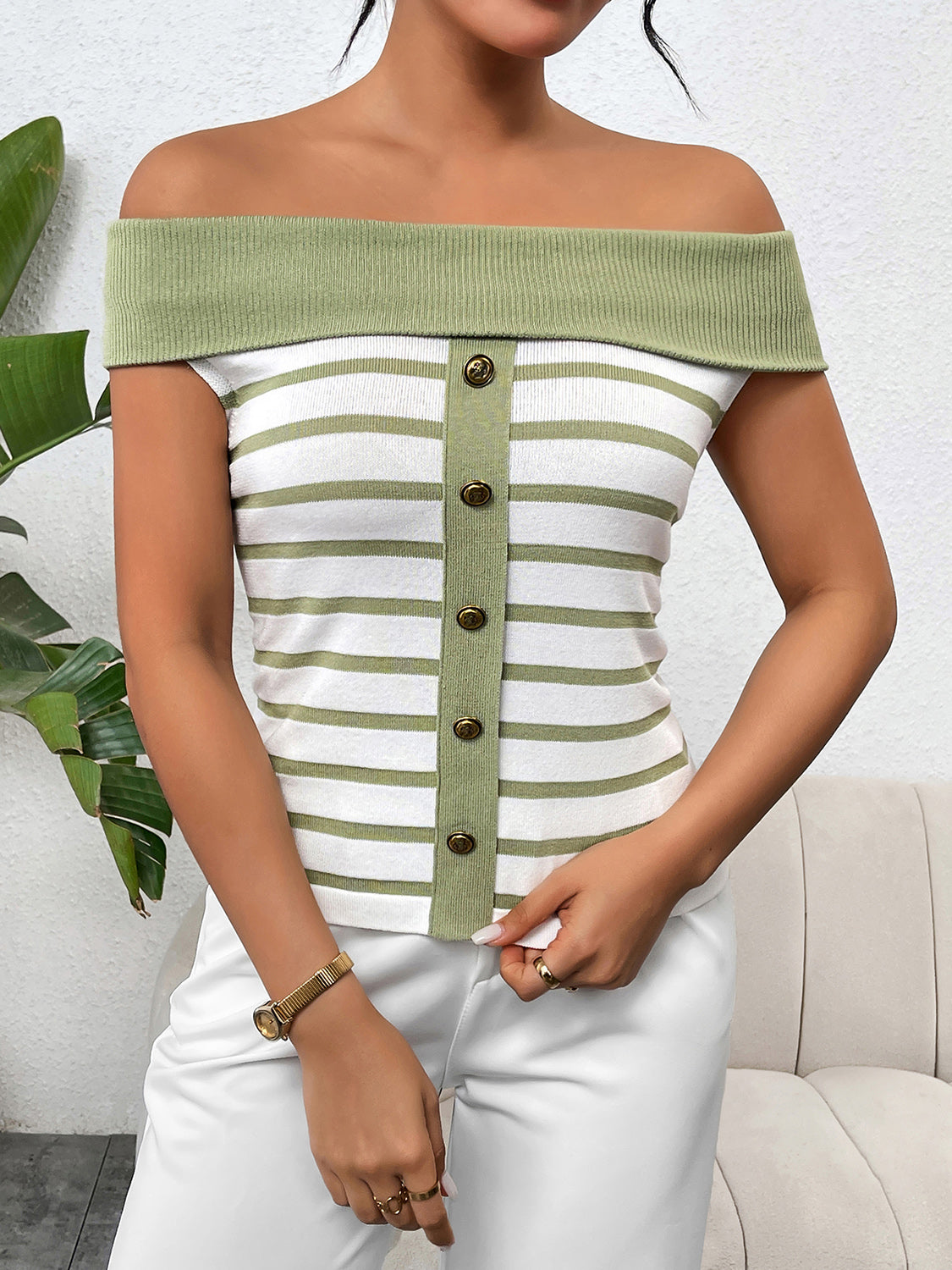 Decorative button striped off-shoulder knit top.