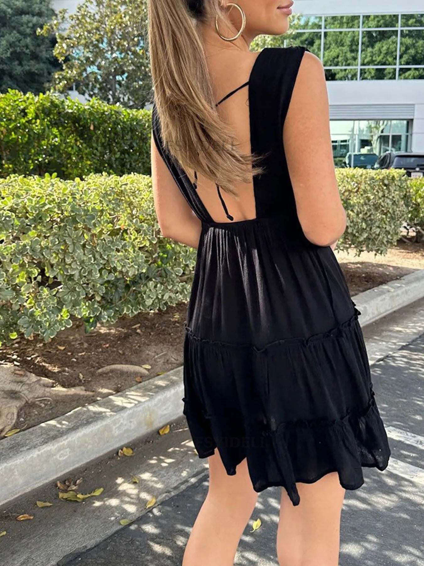 Deep V-Neck Tiered Mini Dress with Ruched, Lace-Up, and Frill Details.