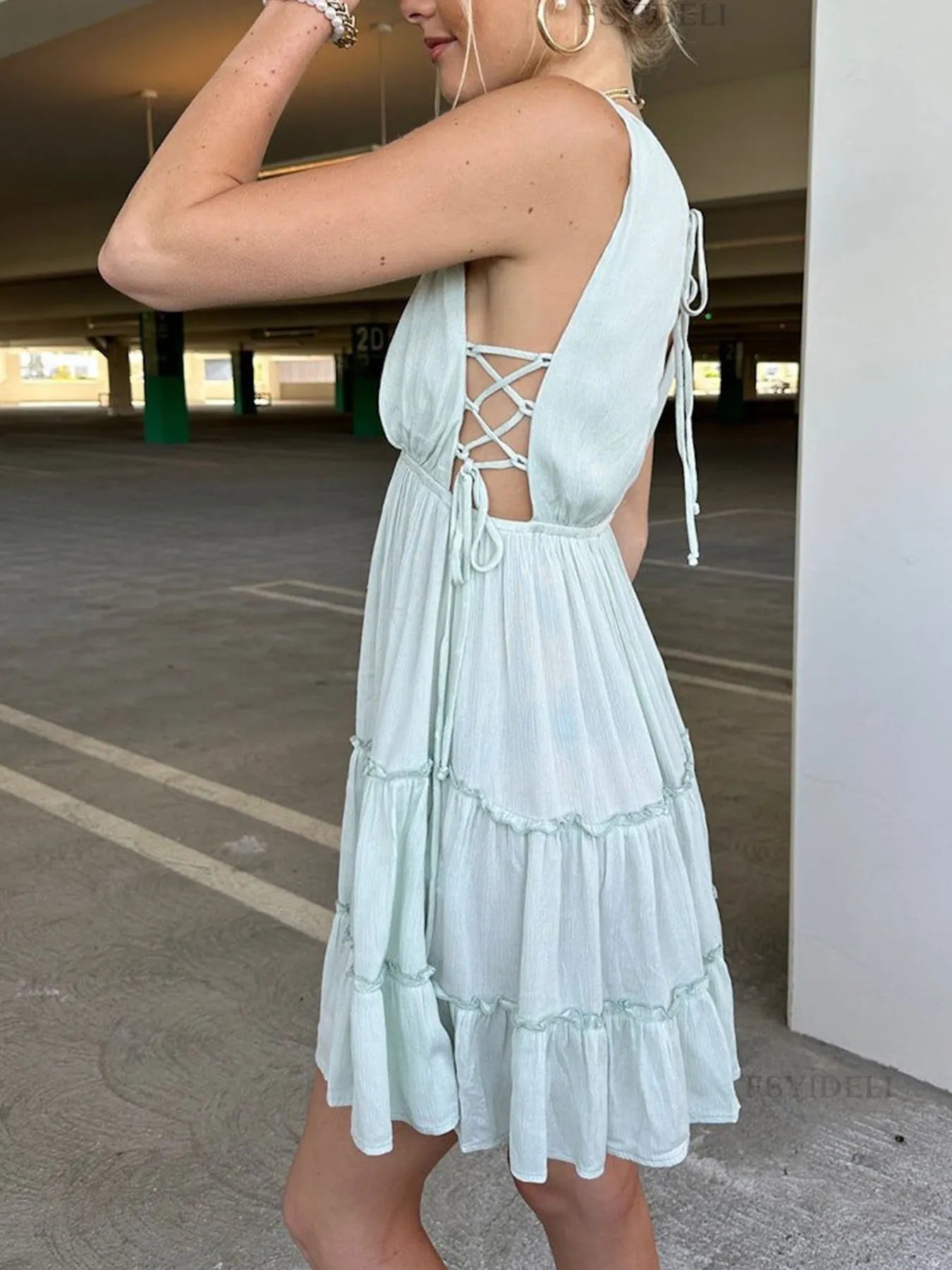 Deep V-Neck Tiered Mini Dress with Ruched, Lace-Up, and Frill Details.