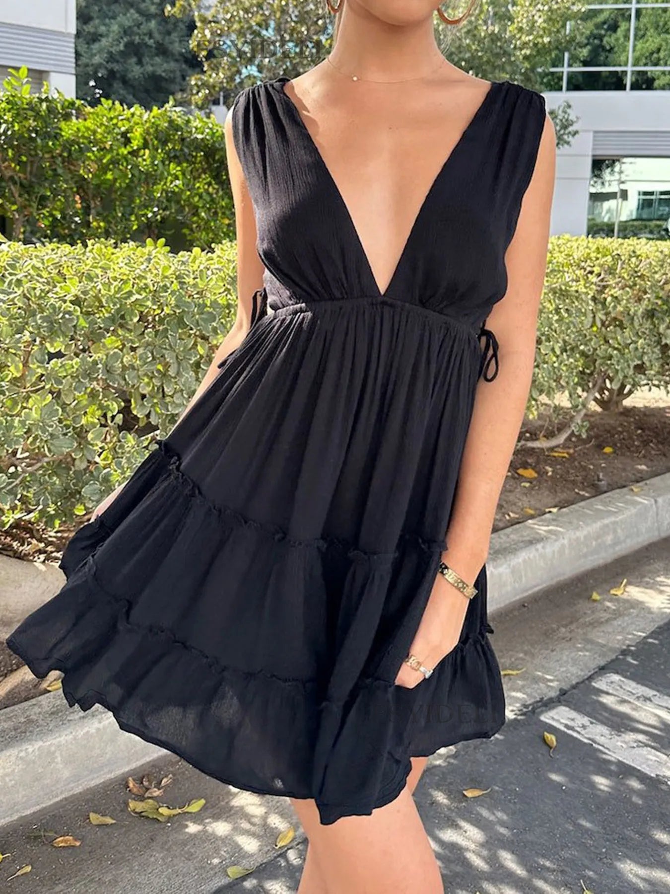 Deep V-Neck Tiered Mini Dress with Ruched, Lace-Up, and Frill Details.