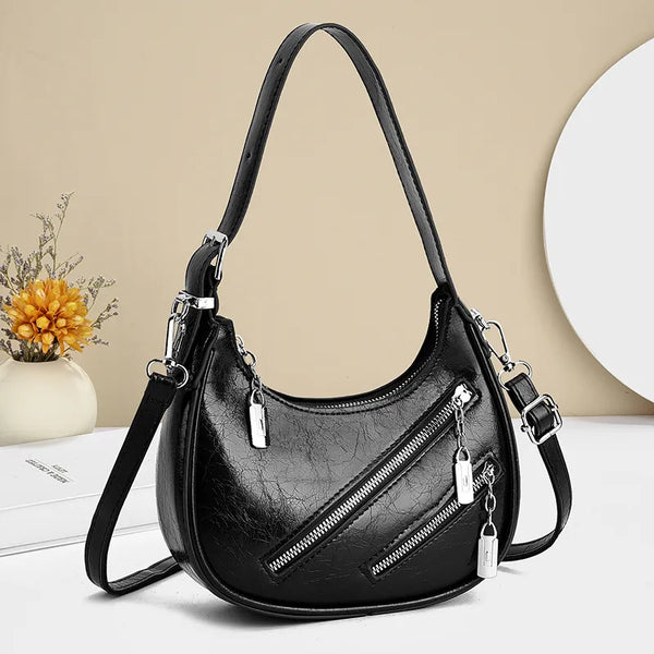 Medium PU leather diagonal zipper shoulder bag.