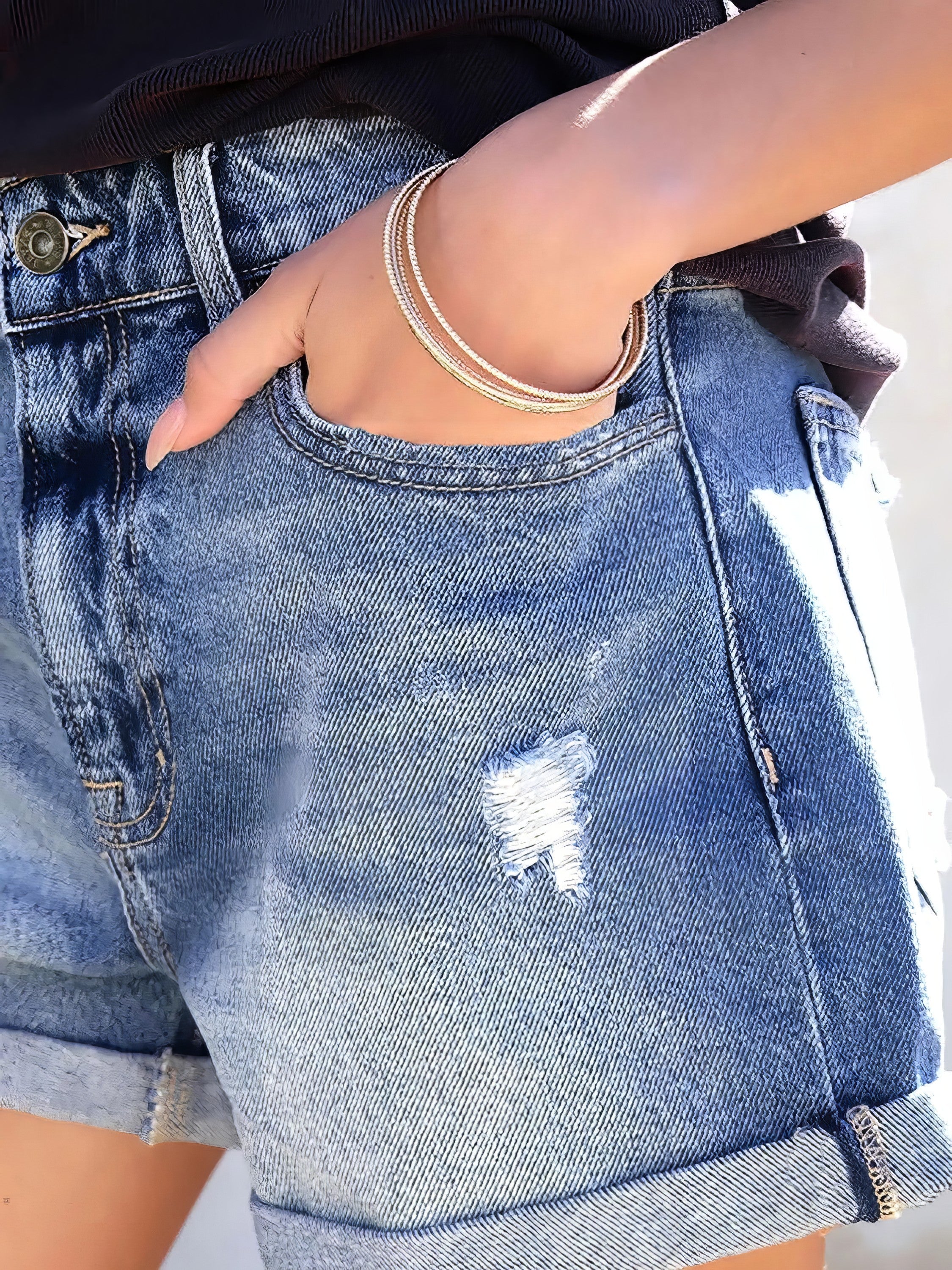 Women's distressed denim shorts with pockets and cat's whisker detail.