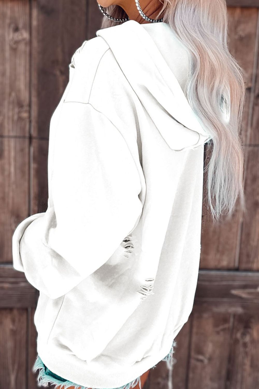 Distressed drawstring long sleeve hoodie with pockets.
