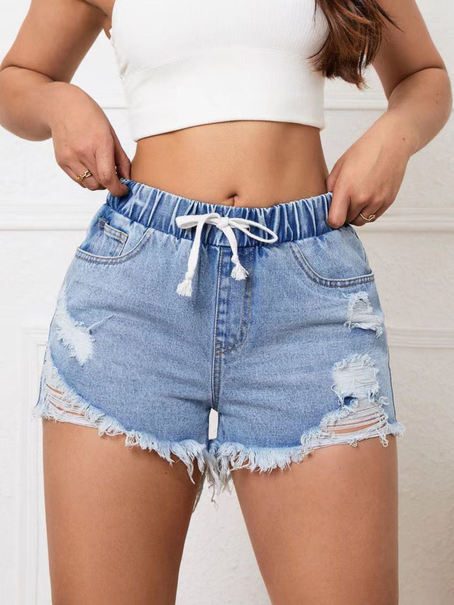 Distressed drawstring raw hem denim shorts with buttons.
