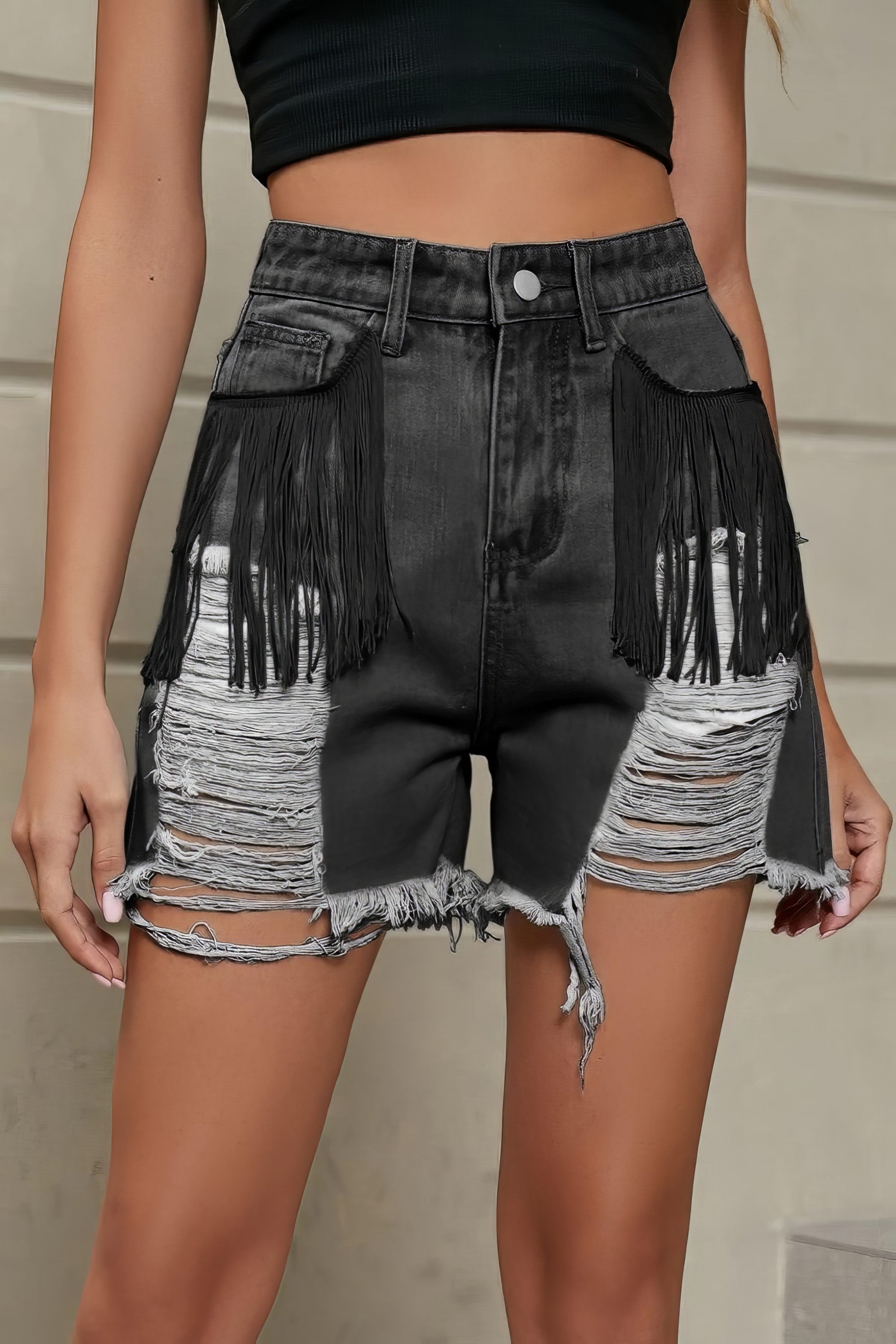 Women's distressed fringe denim shorts with raw hem and pockets.