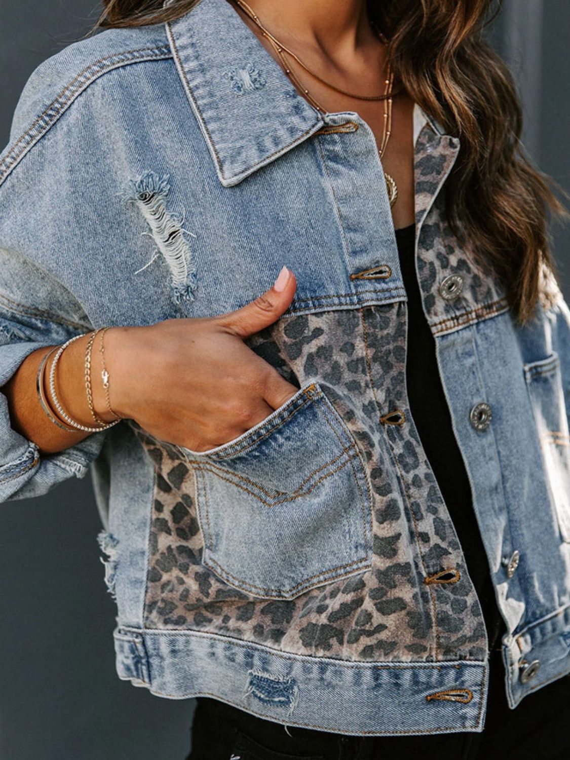 Distressed leopard print drop shoulder denim jacket with pockets.