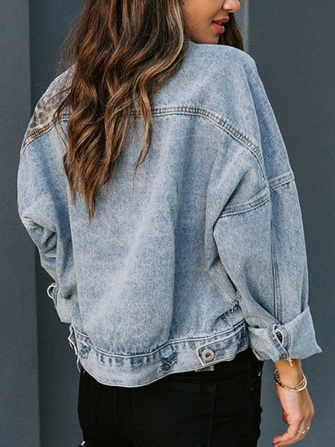 Distressed leopard print drop shoulder denim jacket with pockets.