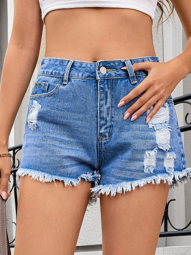 Distressed raw hem denim shorts.