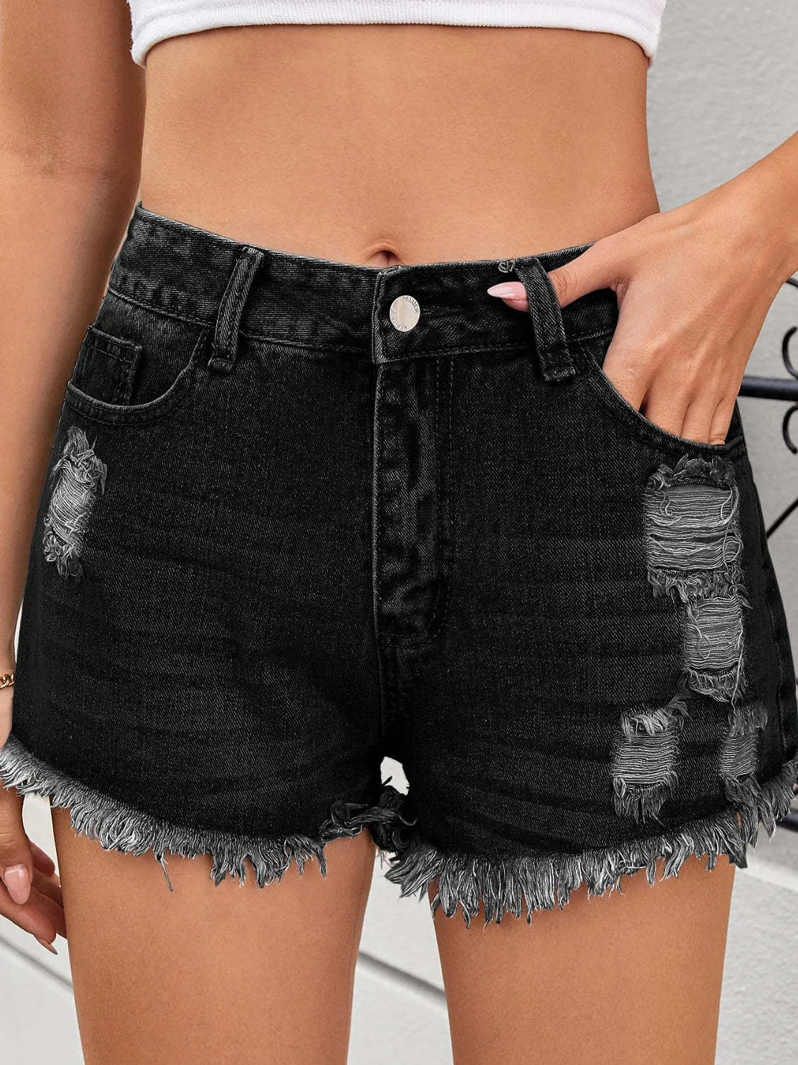 Distressed raw hem denim shorts.