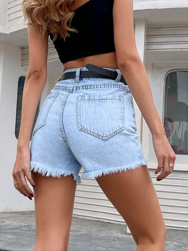Distressed raw hem denim shorts with buttons and pockets.