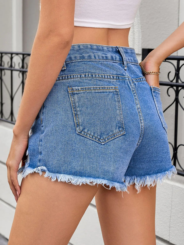 Distressed raw hem denim shorts.