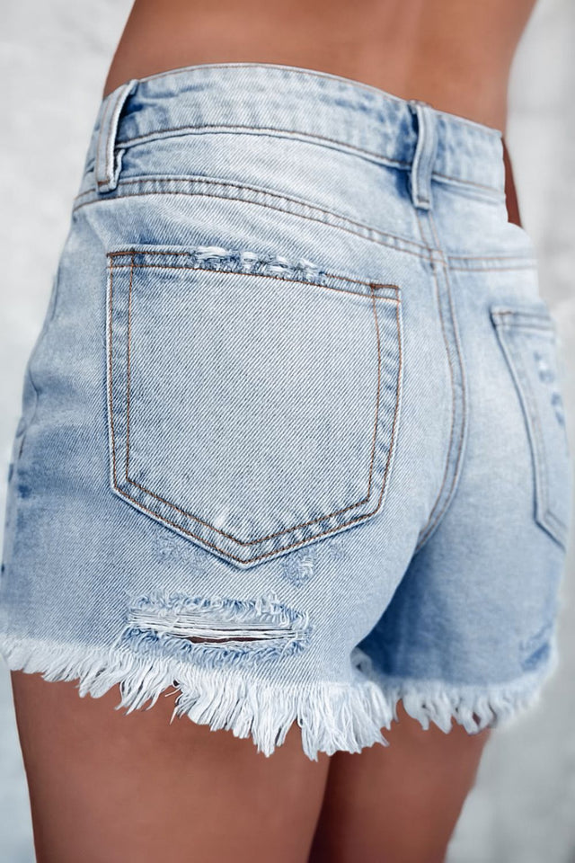 Distressed raw hem high waist denim shorts.