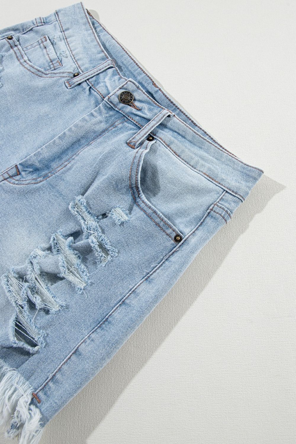 Distressed raw hem high waist denim shorts.