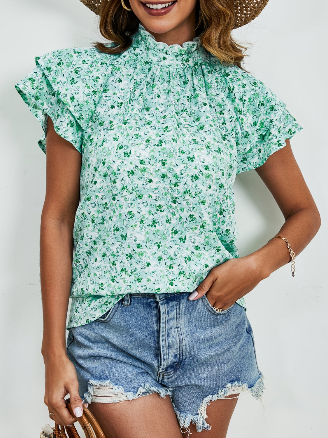 Ditsy floral mock neck flounce sleeve blouse with frill and ruched details.