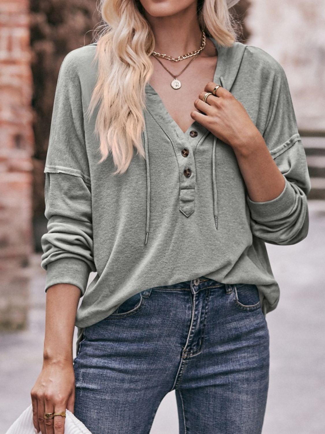 Drawstring drop shoulder long sleeve hoodie with buttons.