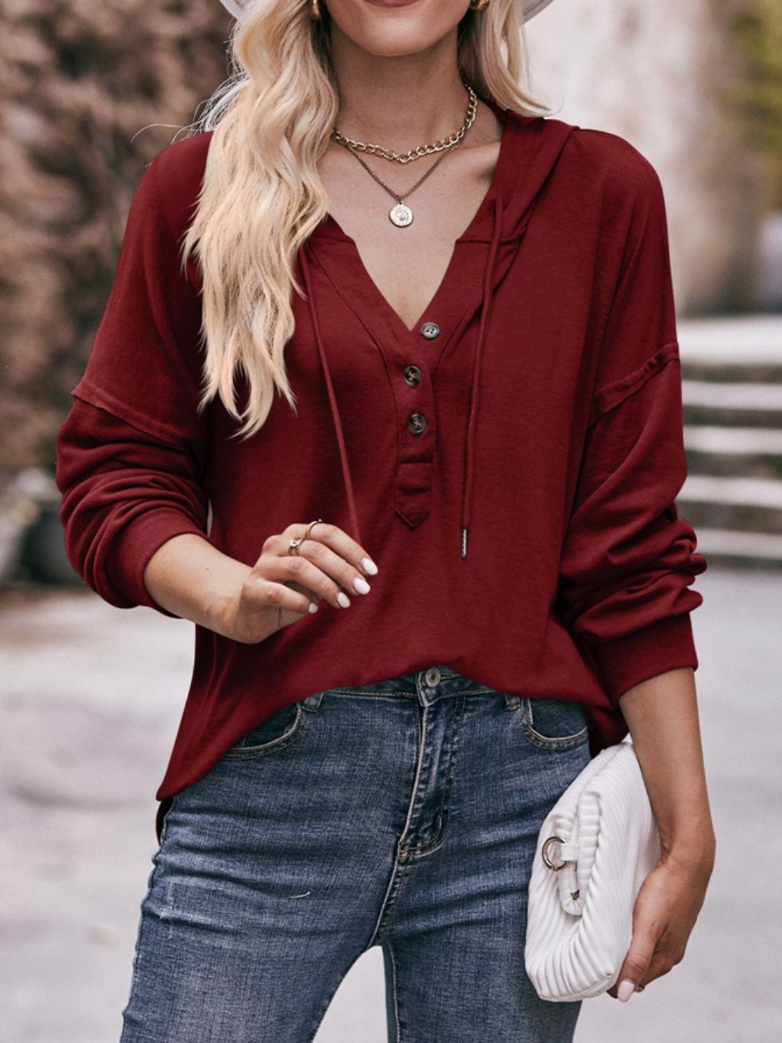 Drawstring drop shoulder long sleeve hoodie with buttons.