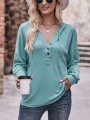 Drawstring drop shoulder long sleeve hoodie with buttons.