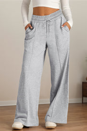 Drawstring elastic waist wide leg pants with pockets, opaque.