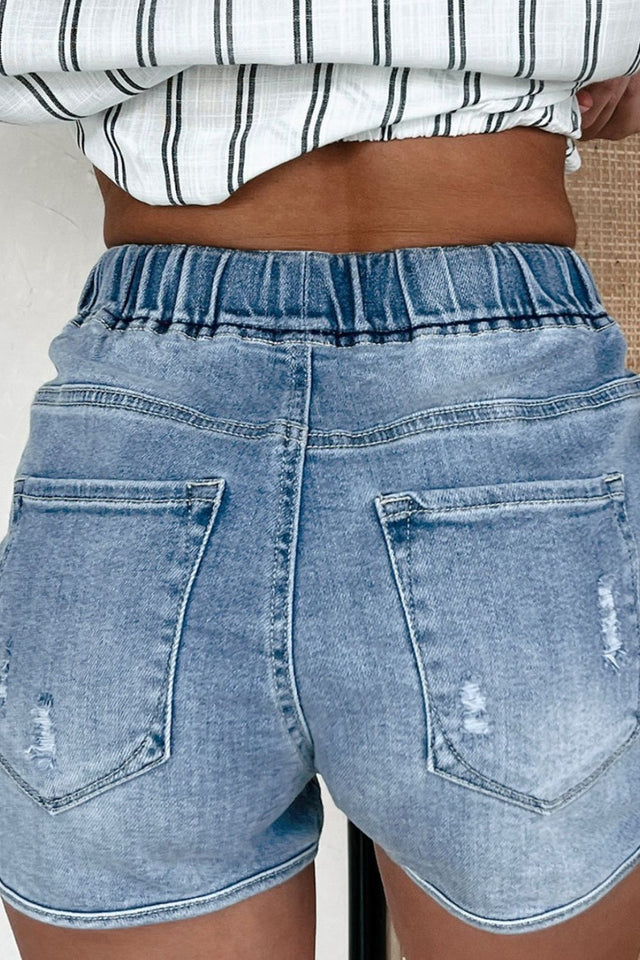 Drawstring high-waist distressed denim shorts with pockets.